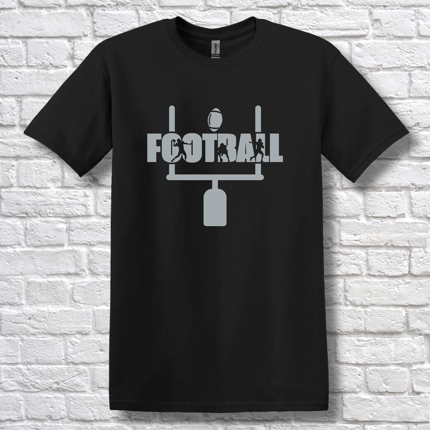 Black t-shirt with 'FOOTBALL' graphic on a white brick wall background