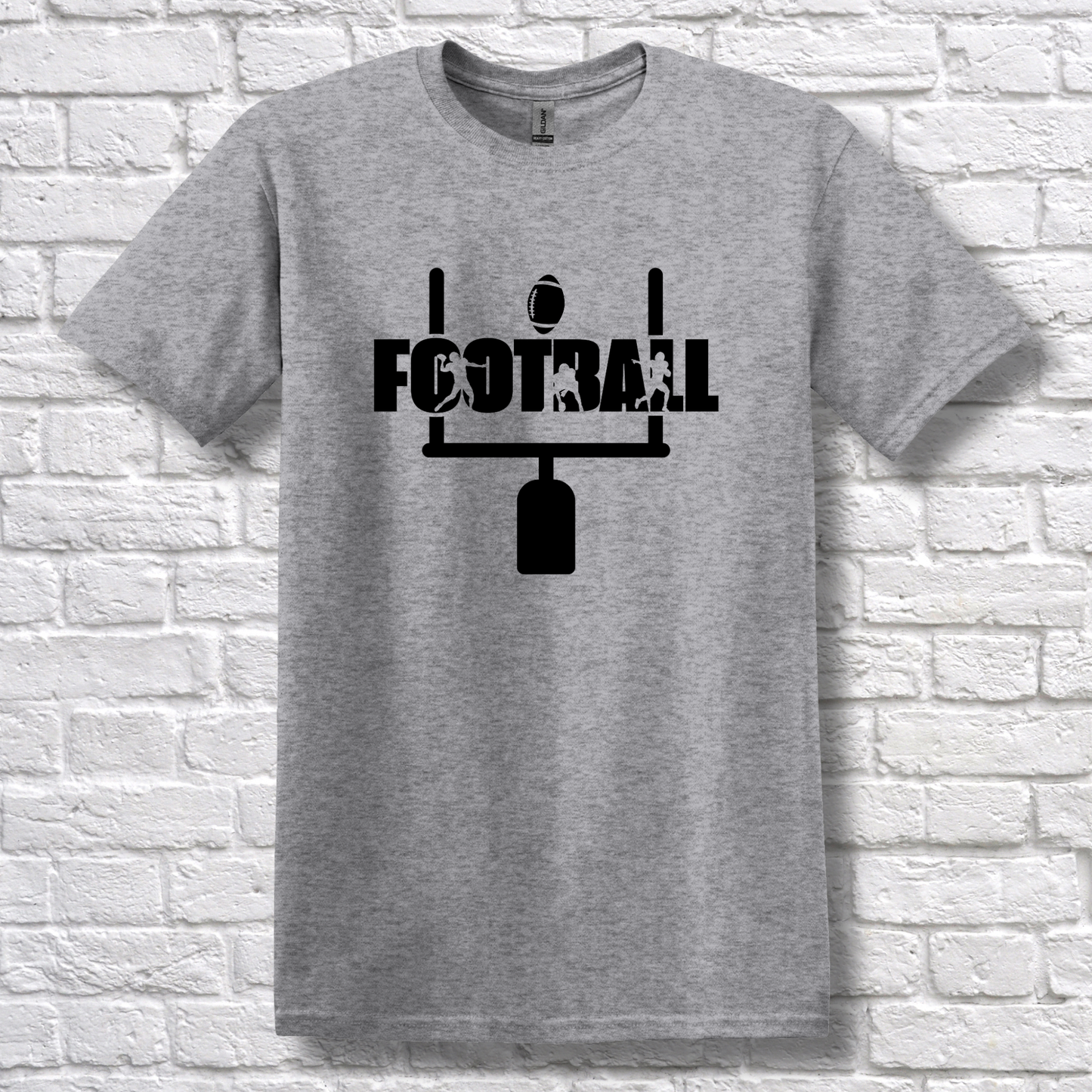 Gray t-shirt with black 'FOOTBALL' graphic on a white brick wall background
