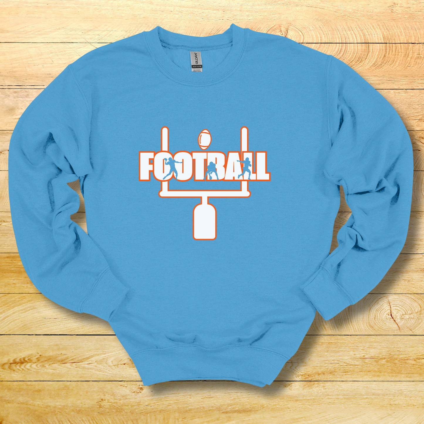 Blue sweatshirt with football graphic on a wooden surface