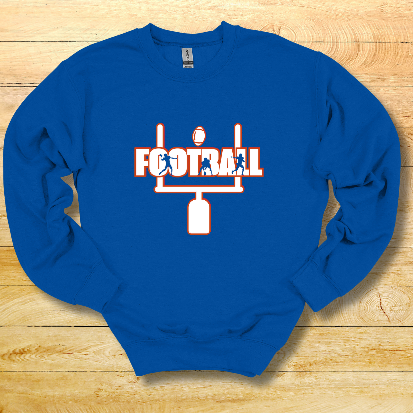 Blue sweatshirt with football graphic on a wooden surface