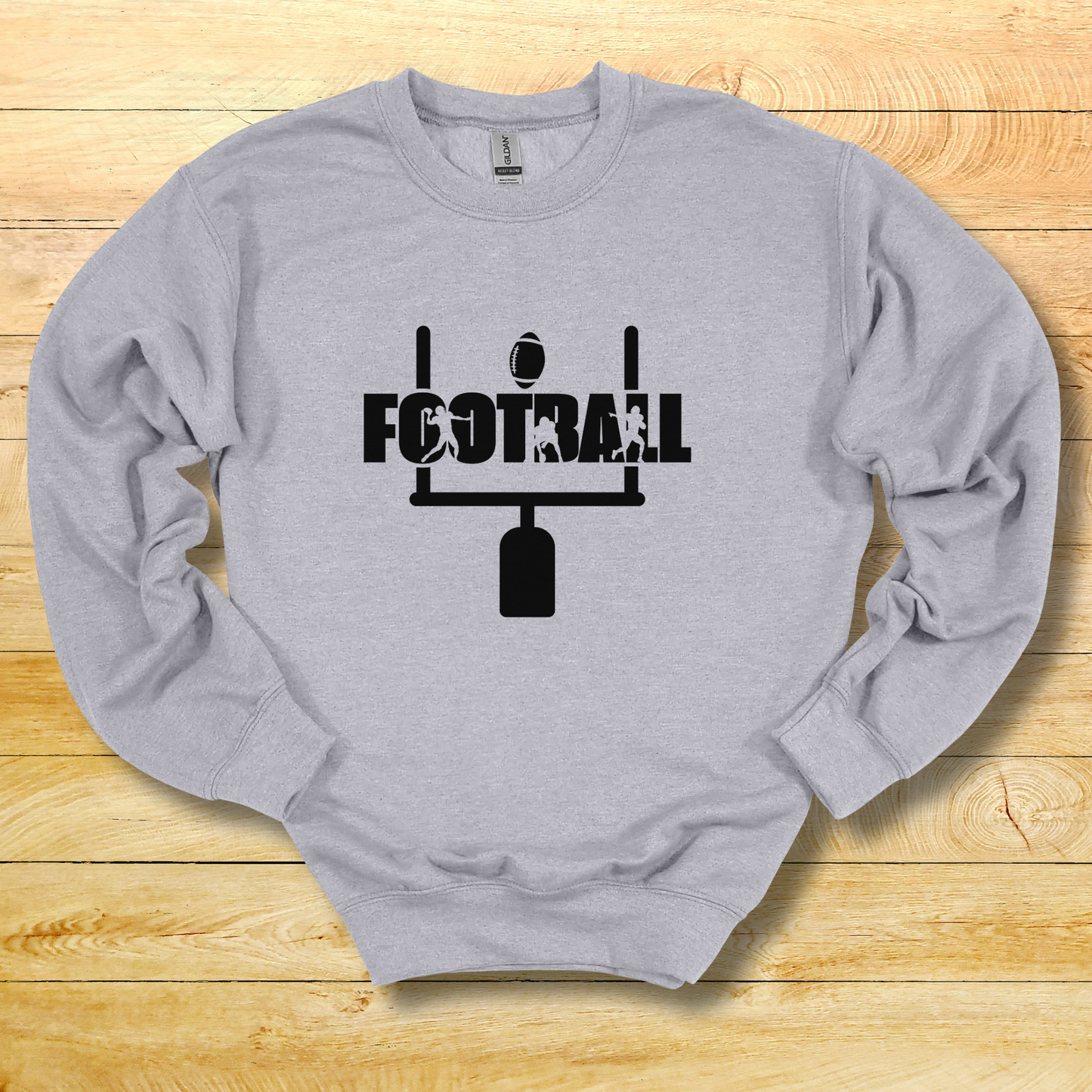 Gray sweatshirt with 'FOOTBALL' graphic on a wooden surface