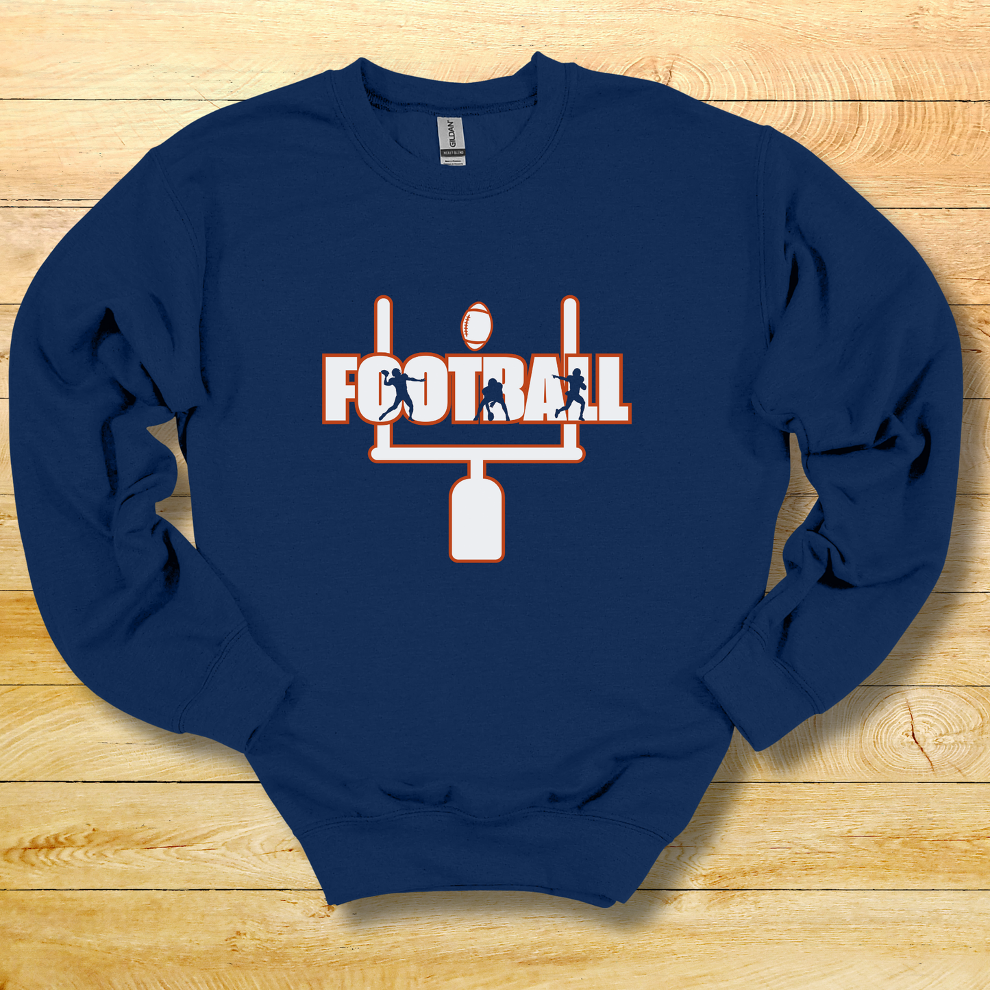 Blue sweatshirt with football graphic and text on a wooden surface