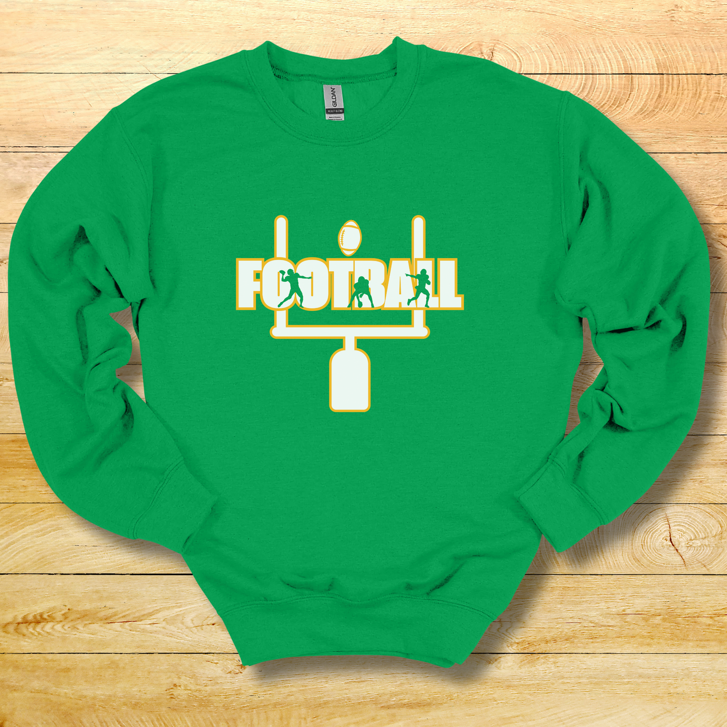 Green sweatshirt with football graphic and text on a wooden surface