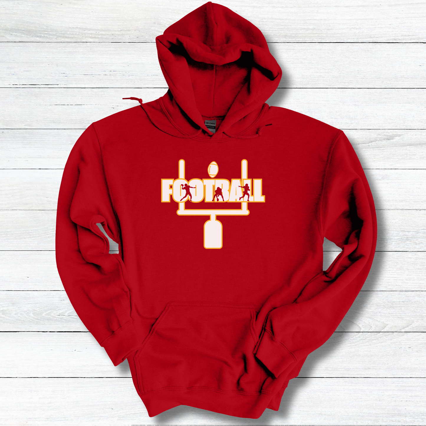 Red hoodie with a white and yellow graphic on a light wooden surface
