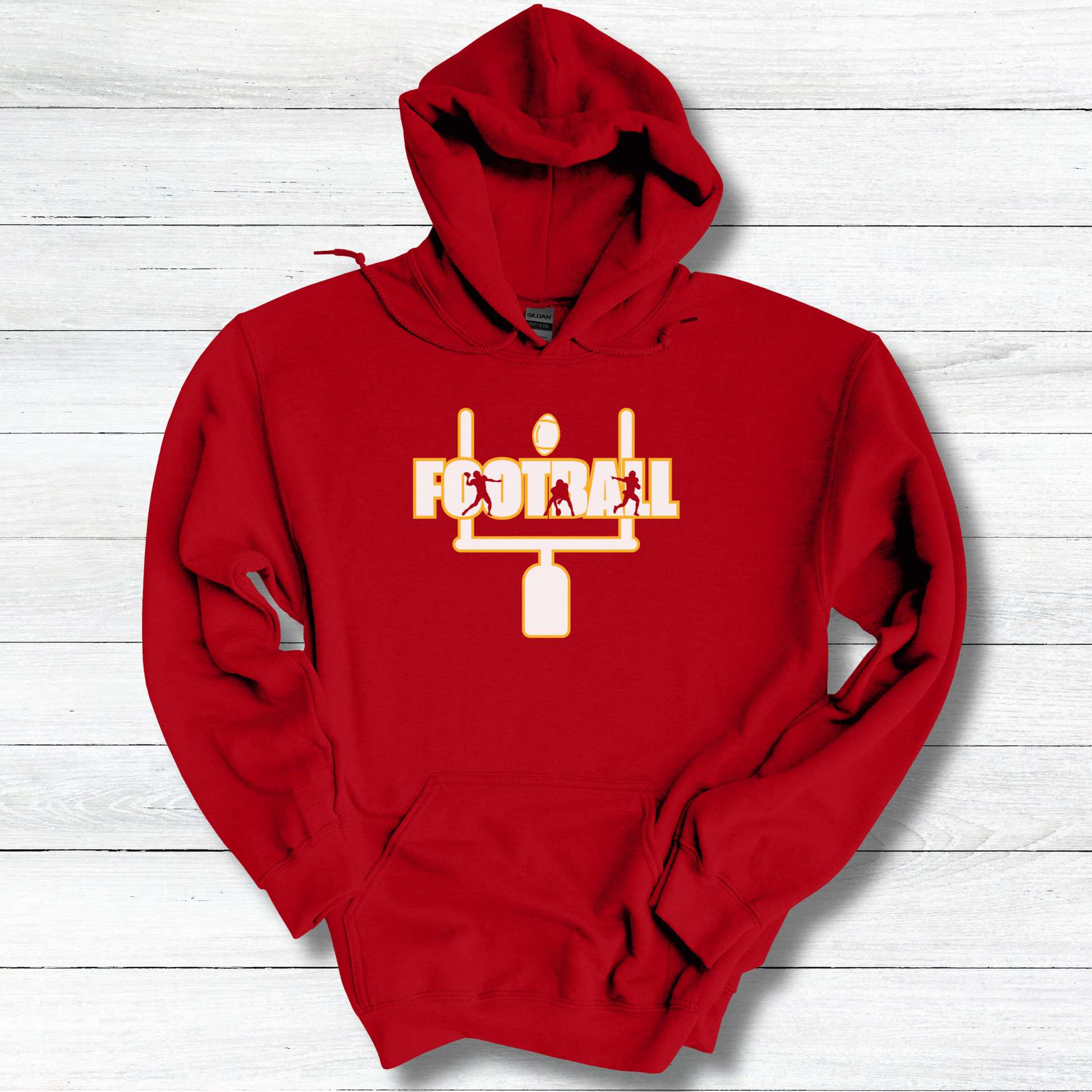 Red hoodie with a white and yellow graphic on a light wooden surface