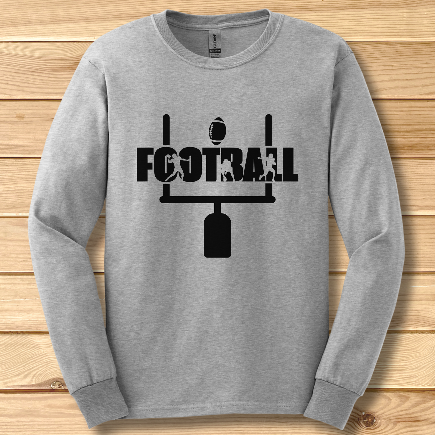 Gray long-sleeve shirt with black 'FOOTBALL' graphic on a wooden surface