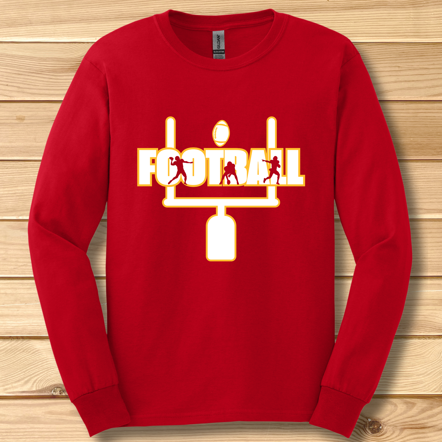 Red long-sleeve shirt with football graphic on a wooden background