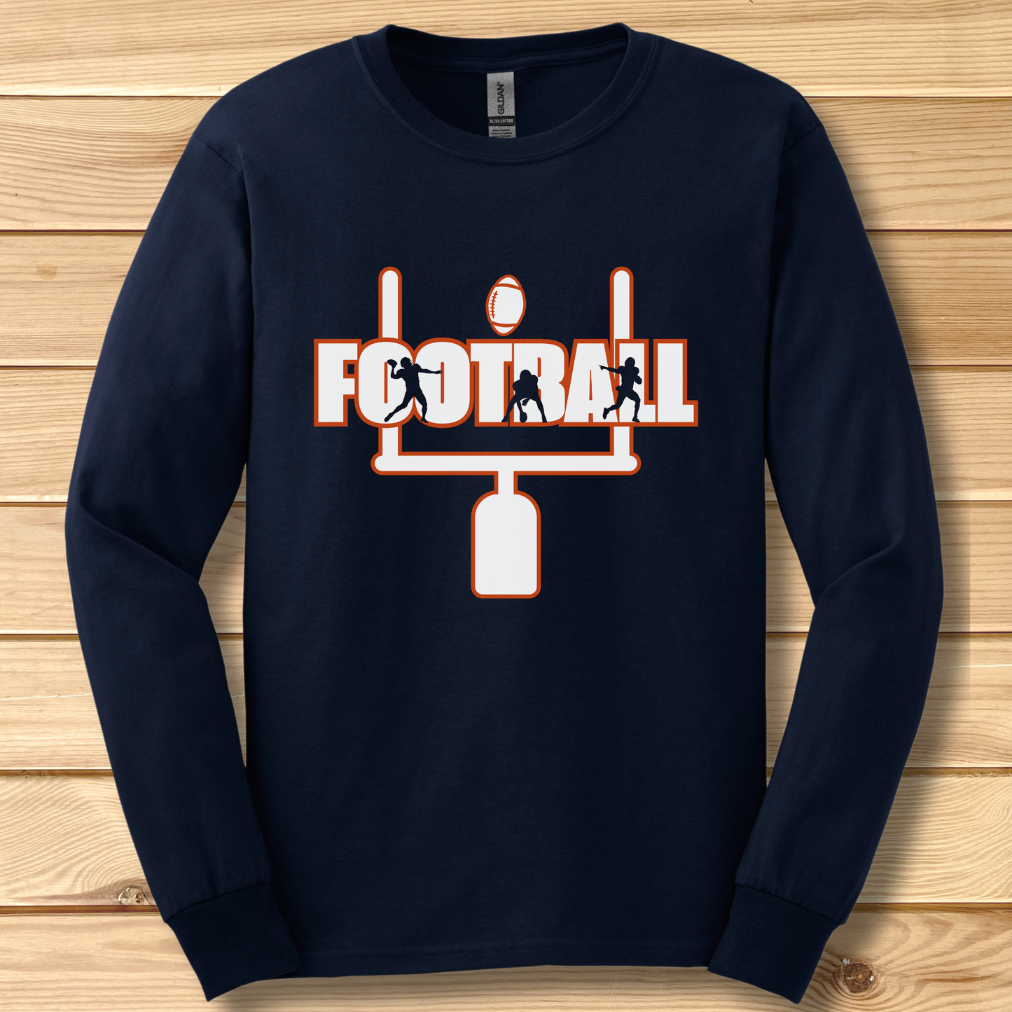 Navy blue long-sleeve shirt with football graphic on a wooden surface