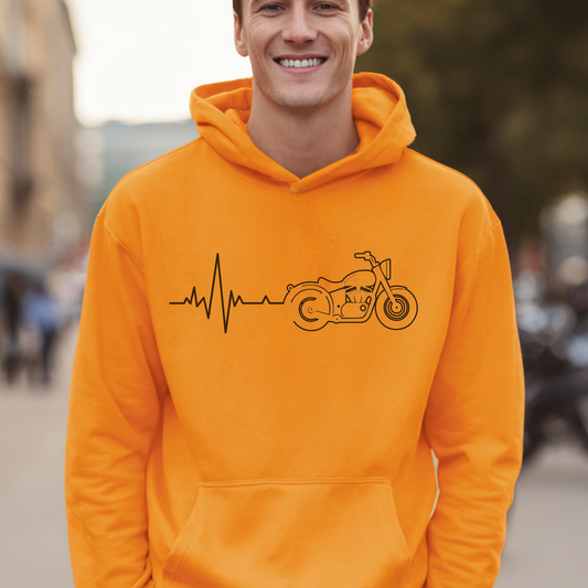 Man wearing an orange hoodie with a motorcycle and heartbeat line design, standing outdoors.