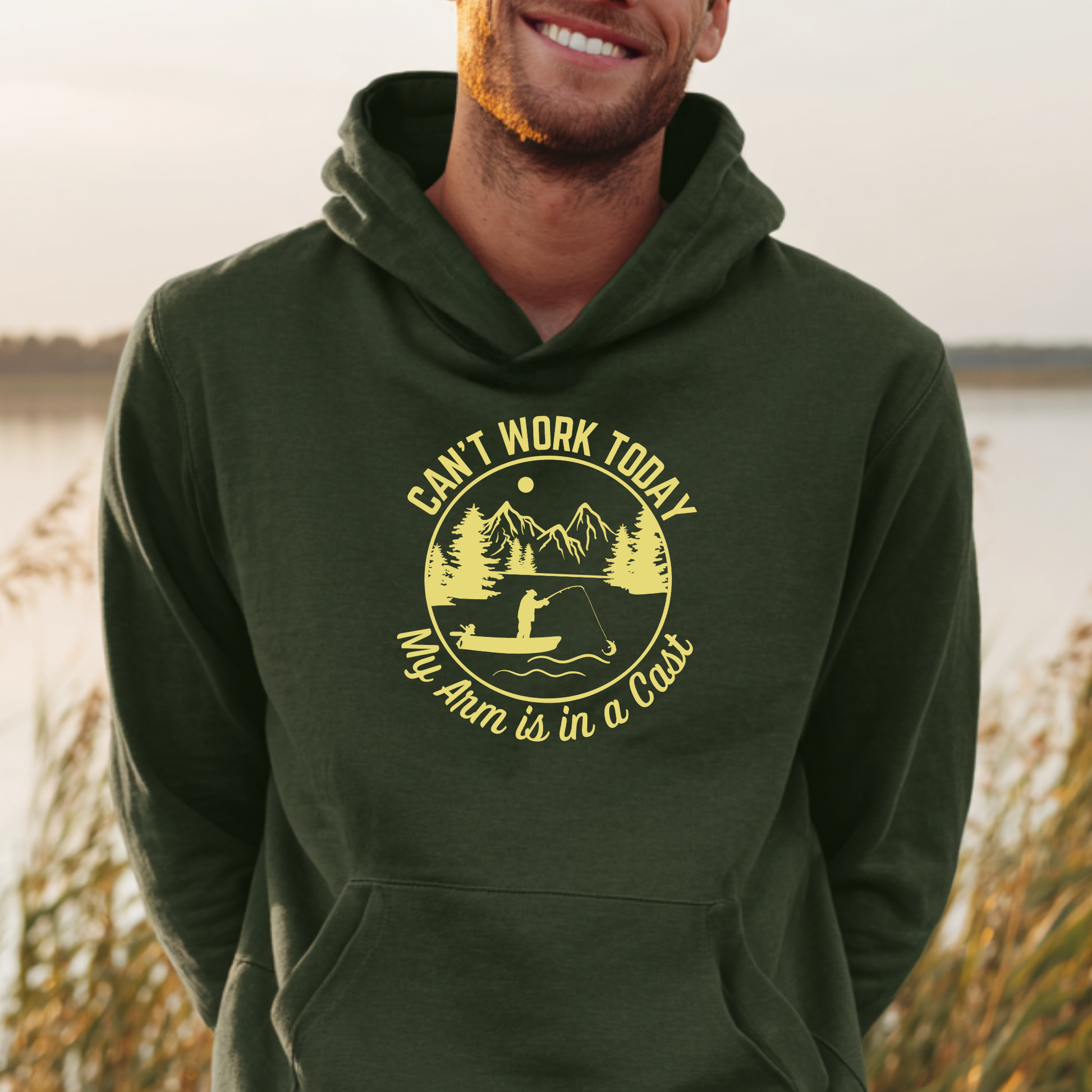 Person wearing a green hoodie with a yellow graphic and text, standing outdoors.