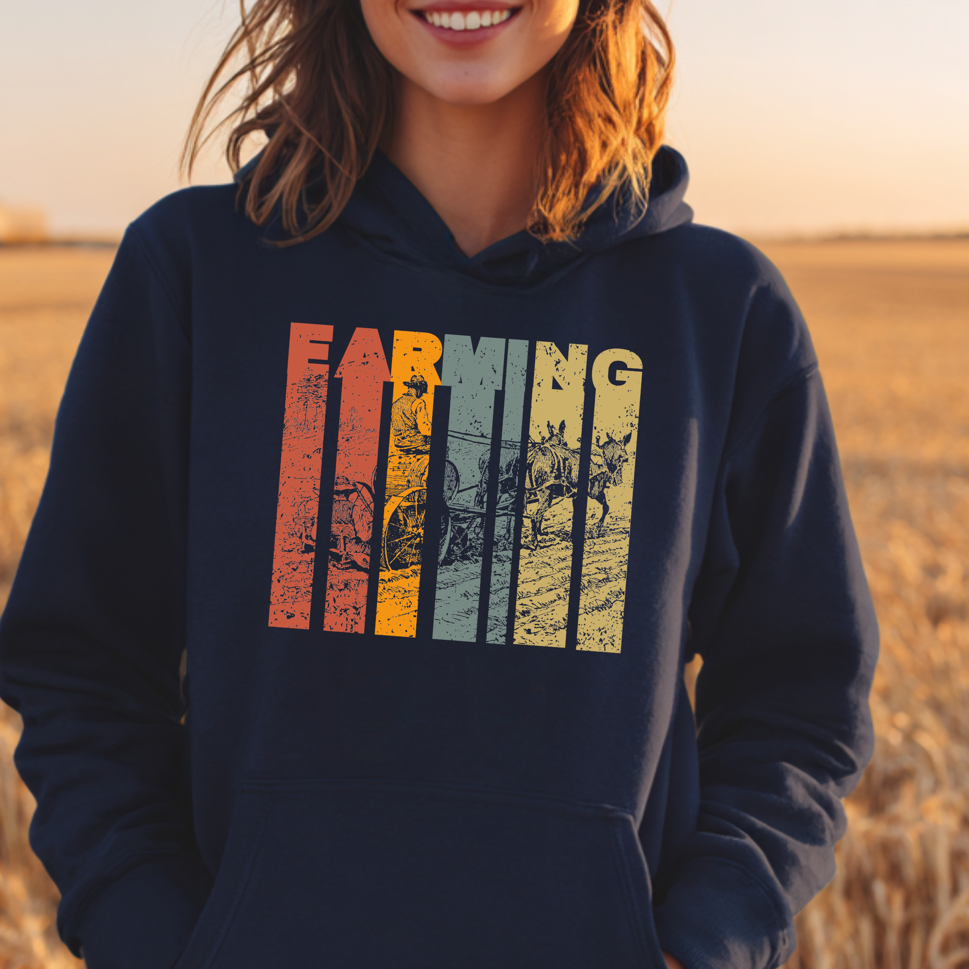 Person wearing a navy hoodie with colorful graphic design in a field