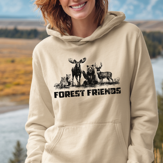 Person wearing a beige hoodie with forest-themed design and 'FOREST FRIENDS' text, outdoors.