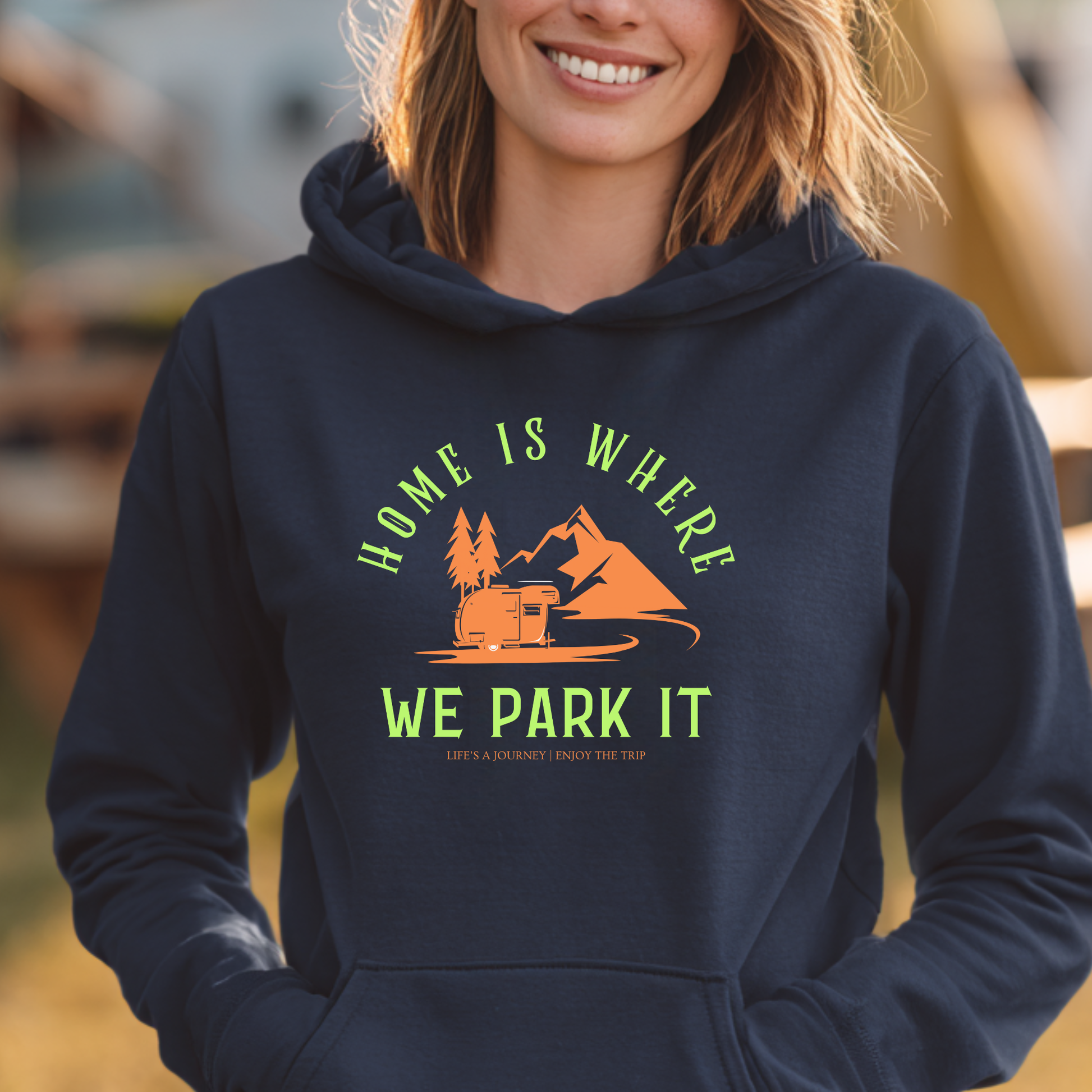 Person wearing a navy hoodie with a camping graphic and text.