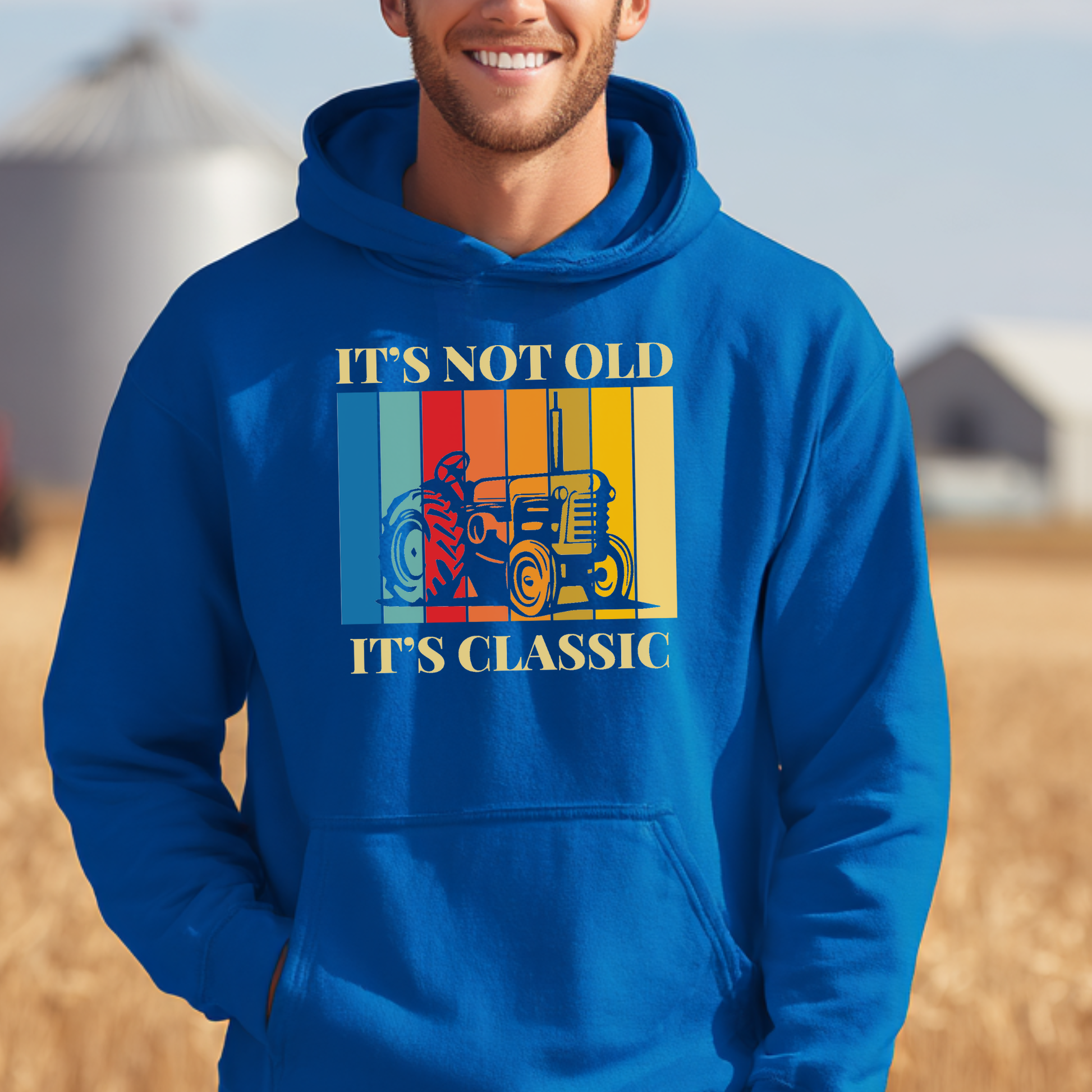 Person wearing a blue hoodie with a graphic and text in an outdoor setting