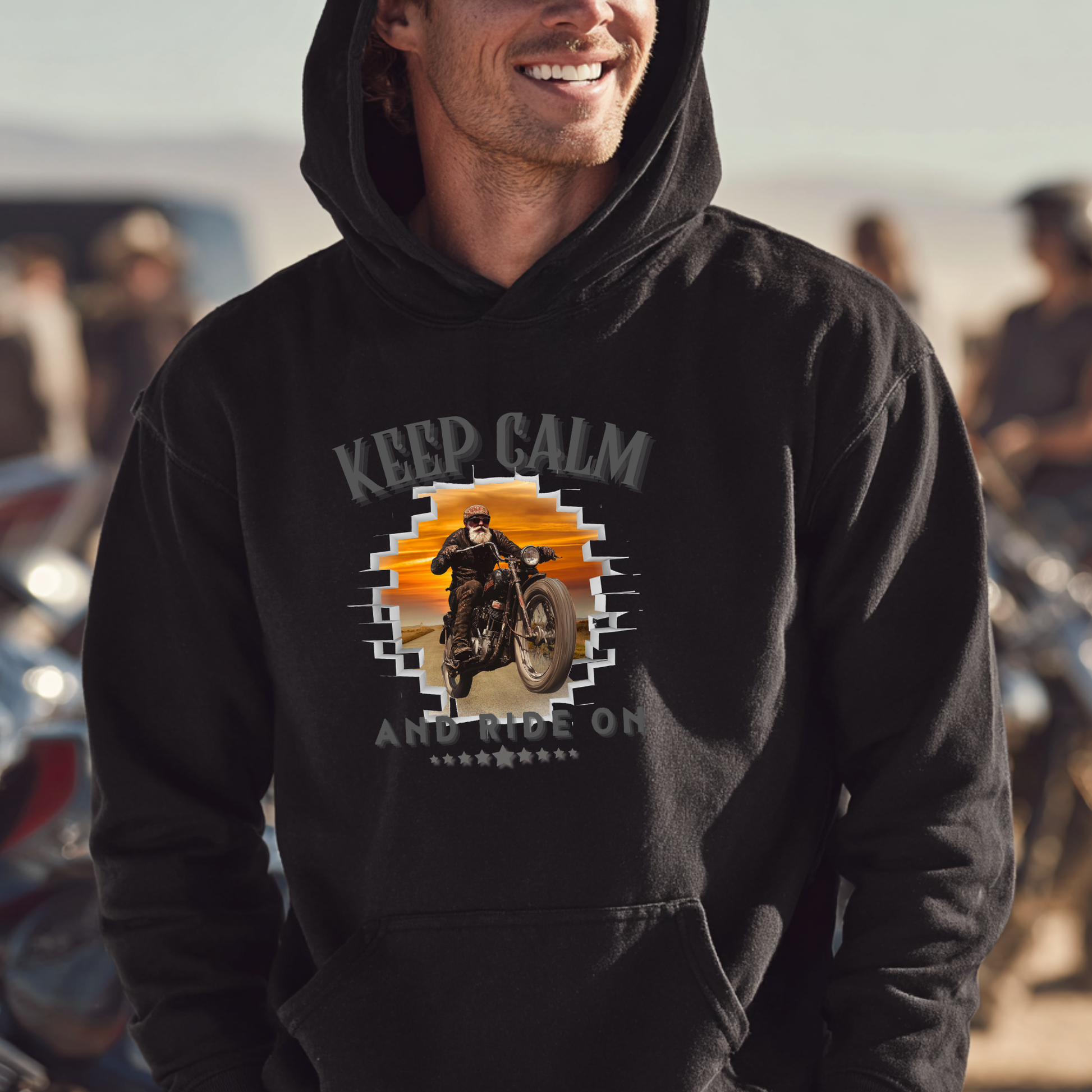 Man wearing a black hoodie with a graphic design and text 'Keep Calm and Ride On' in an outdoor setting.