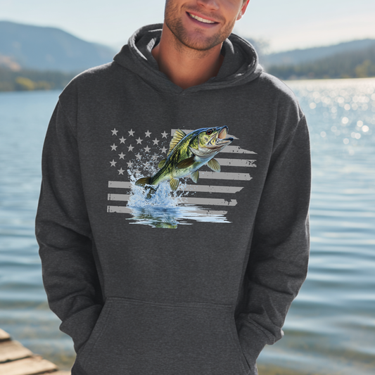 Man wearing a hoodie with a fish and American flag design by a lake.