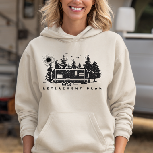 Person wearing a beige hoodie with a graphic design and text in an outdoor setting