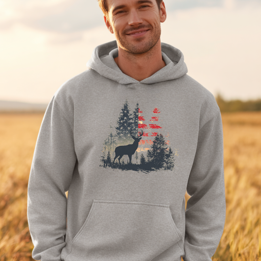 Man wearing a gray hoodie with a nature-themed design in a field