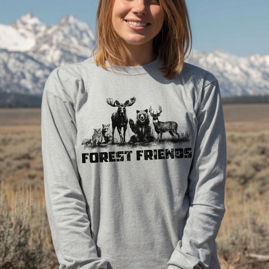 Person wearing a gray sweatshirt with forest-themed design and 'Forest Friends' text, standing in a natural landscape.
