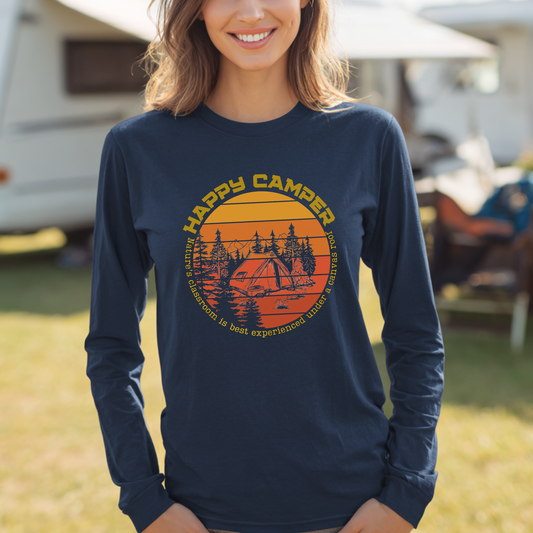 Person wearing a navy blue long-sleeve shirt with 'Happy Camper' graphic in an outdoor setting
