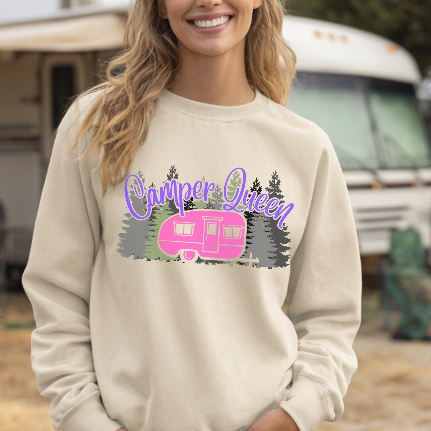Person wearing a beige sweatshirt with 'Camper Queen' graphic in front of an RV.