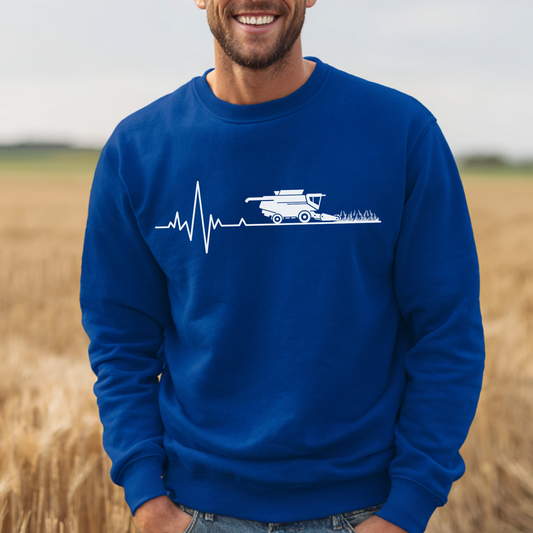 Man wearing a blue sweatshirt with a white graphic in a field