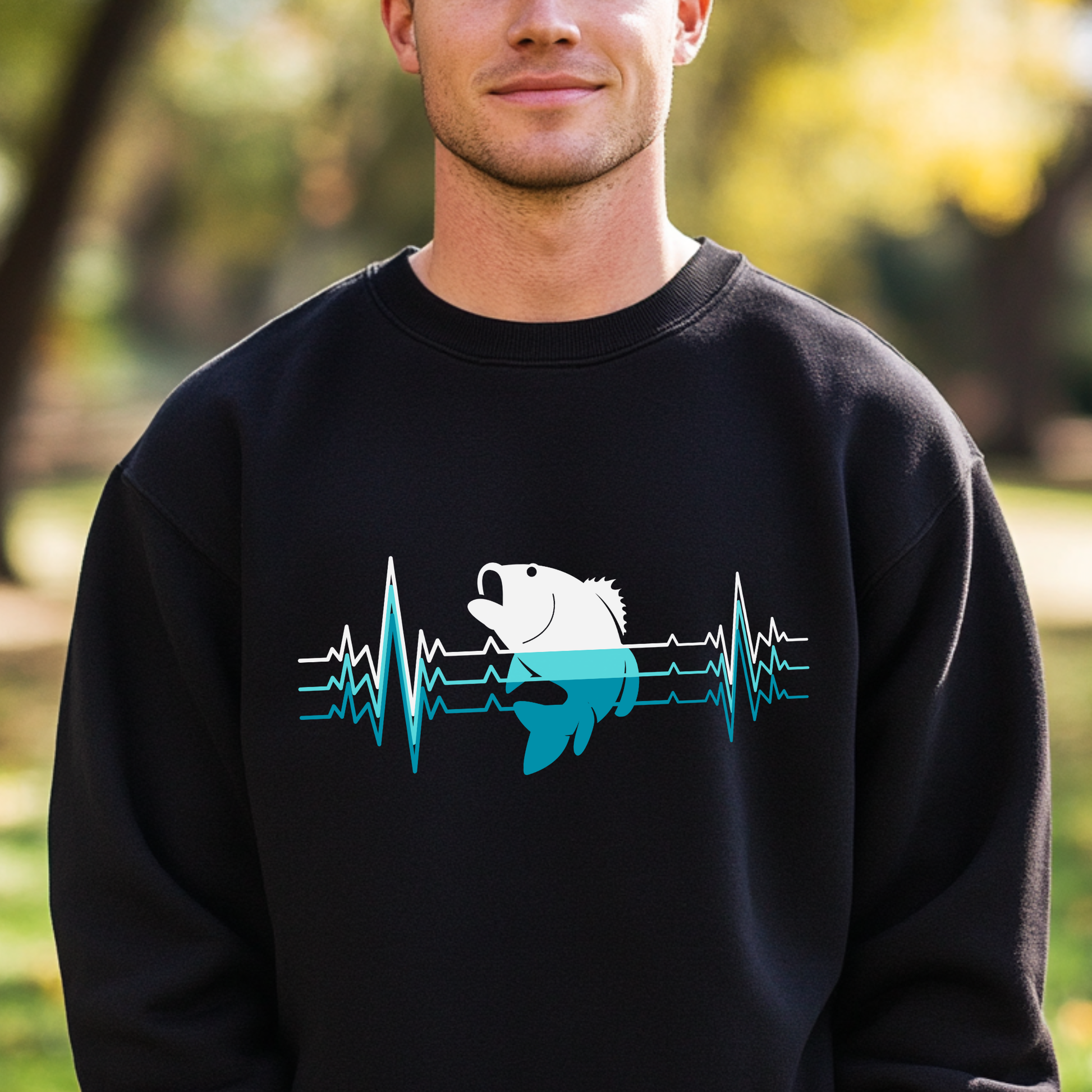 Person wearing a black sweatshirt with a fish and heartbeat design outdoors