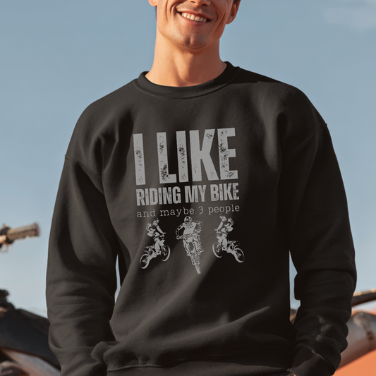 Person wearing a black sweatshirt with 'I LIKE RIDING MY BIKE and maybe 3 people' text and graphics.