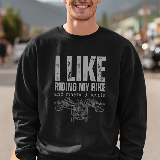 Person wearing a black sweatshirt with 'I Like Riding My Bike and Maybe 3 People' text and graphic.