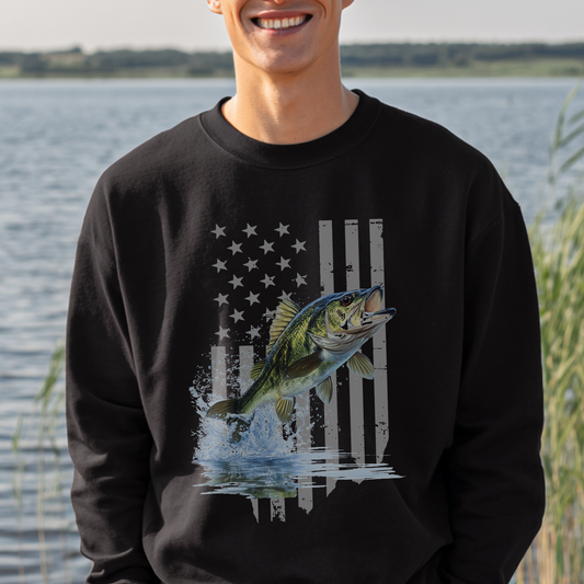 Person wearing a black sweatshirt with a fish graphic in front of a water background