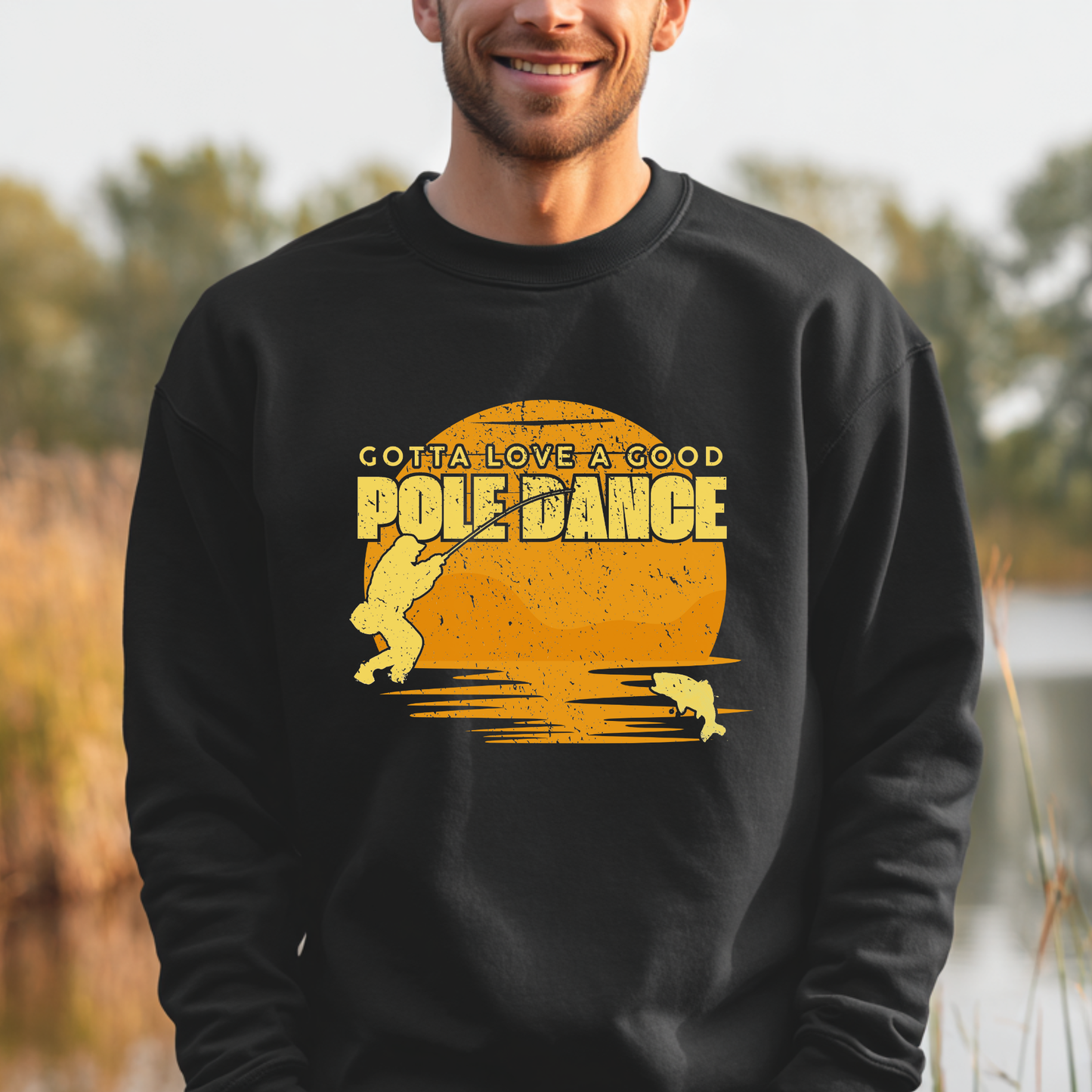 Person wearing a black sweatshirt with yellow graphic and text outdoors