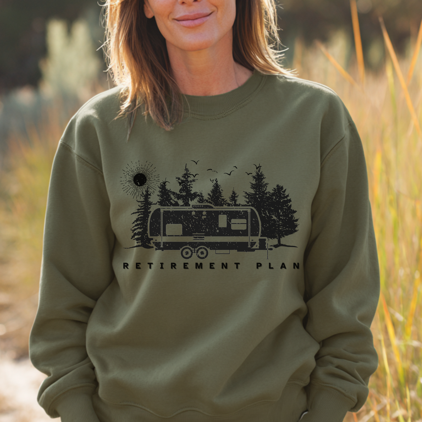 Person wearing a green sweatshirt with a graphic design and text in a natural setting