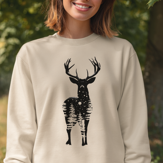 Person wearing a beige sweatshirt with a black deer graphic outdoors