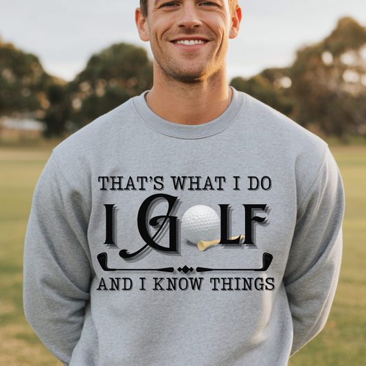 Man wearing a gray sweatshirt with golf-themed text in an outdoor setting