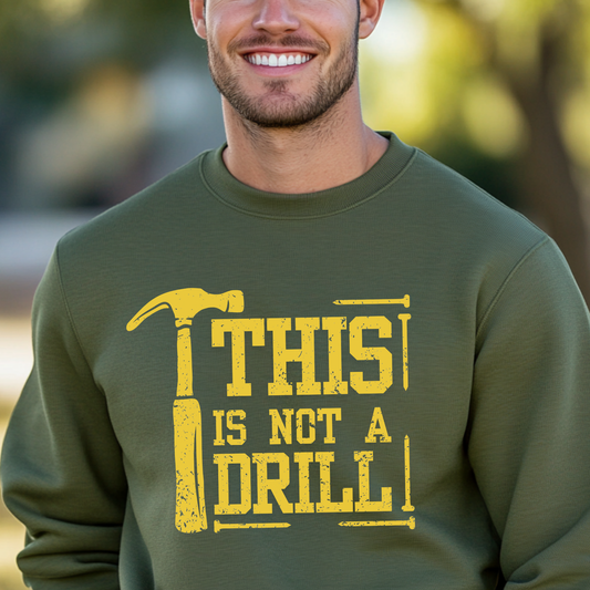 Man wearing a green sweatshirt with a yellow graphic and text outdoors