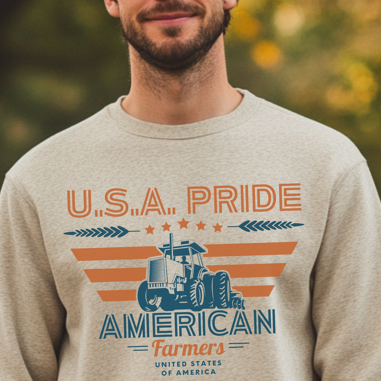 Man wearing a beige sweatshirt with 'U.S.A. Pride American Farmers' design.