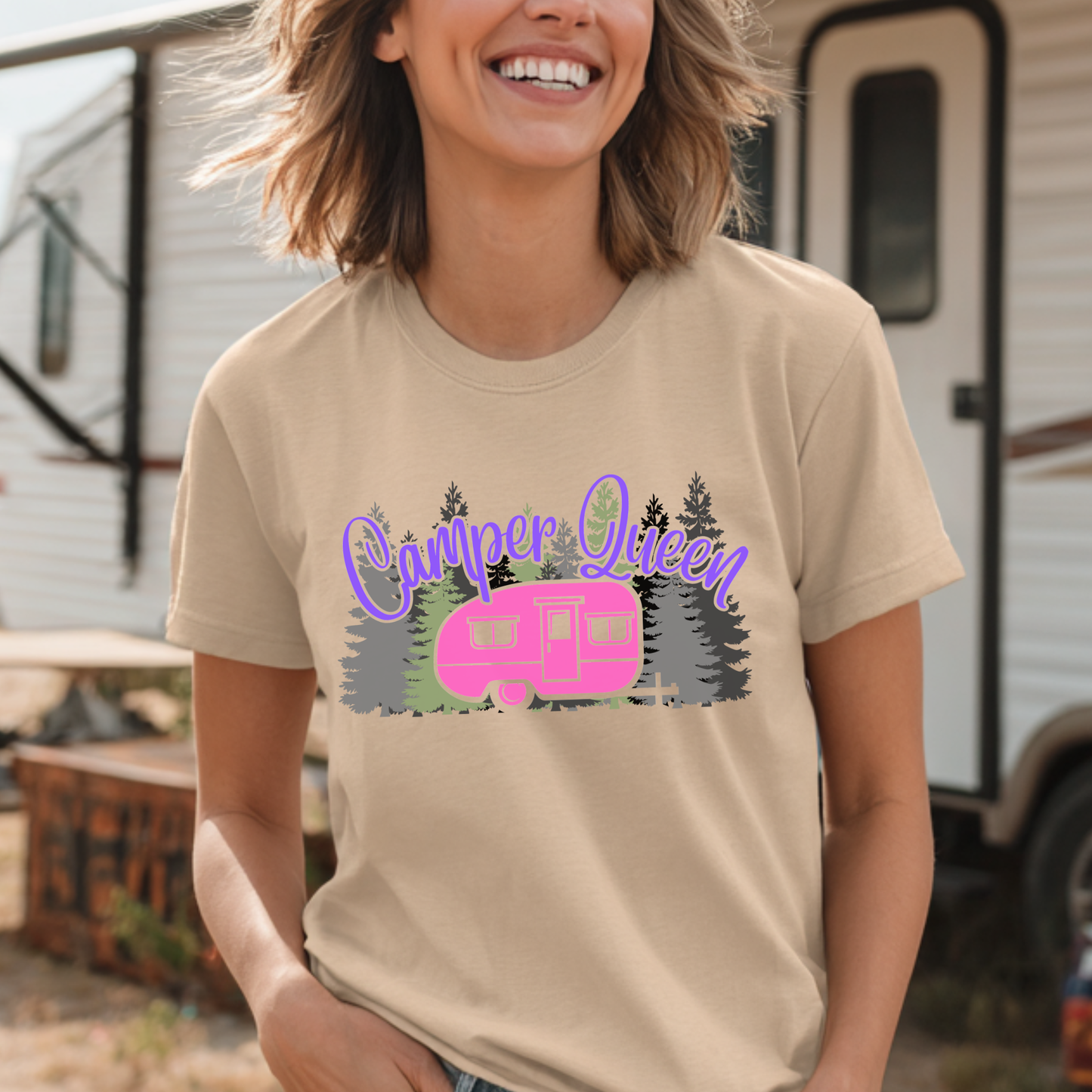 Person wearing a 'Camper Queen' t-shirt with a pink camper graphic in front of an RV.