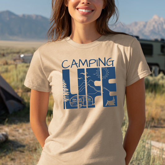 Person wearing a 'Camping Life' t-shirt with a scenic design in a camping setting.