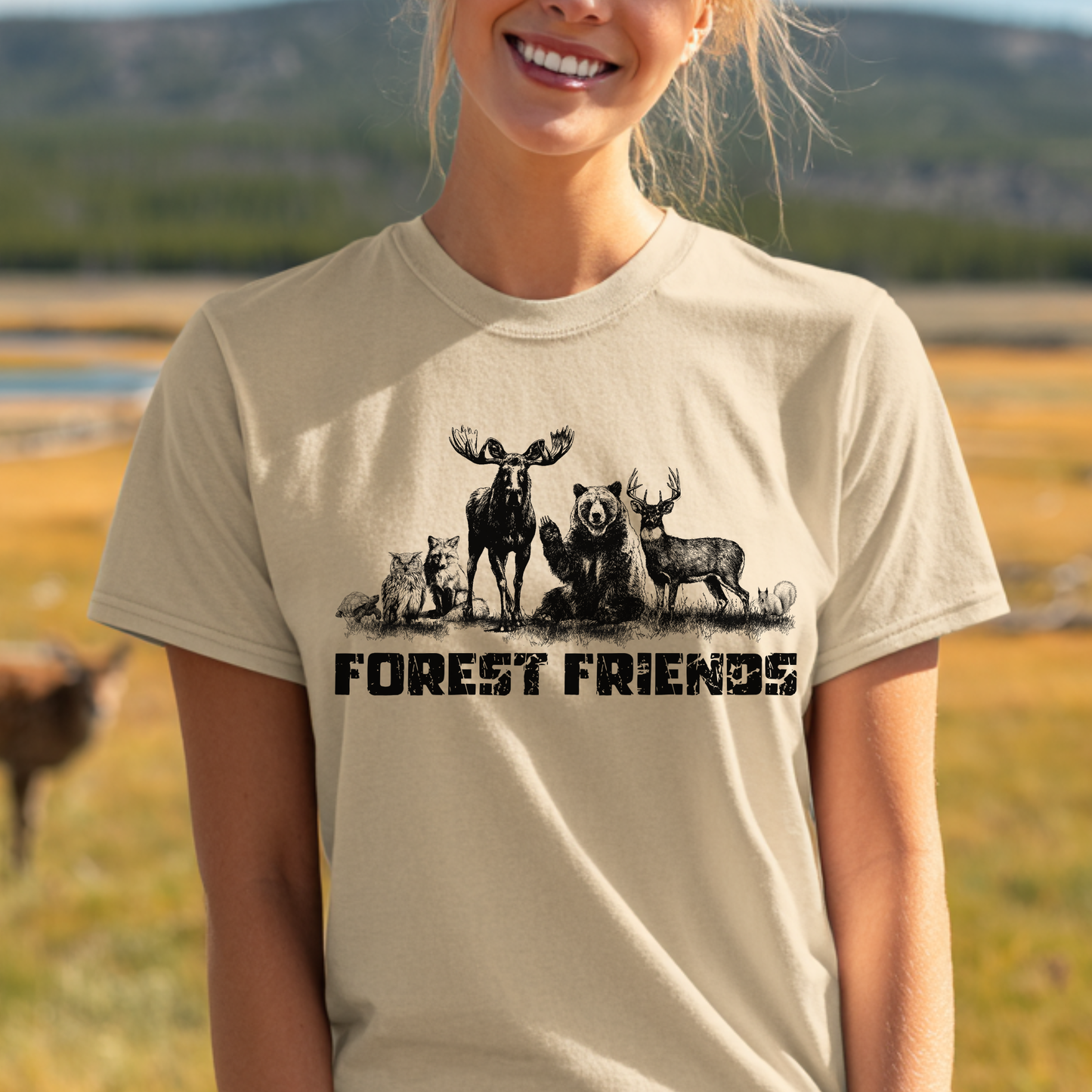 Person wearing a t-shirt with 'Forest Friends' design featuring animals in a natural setting