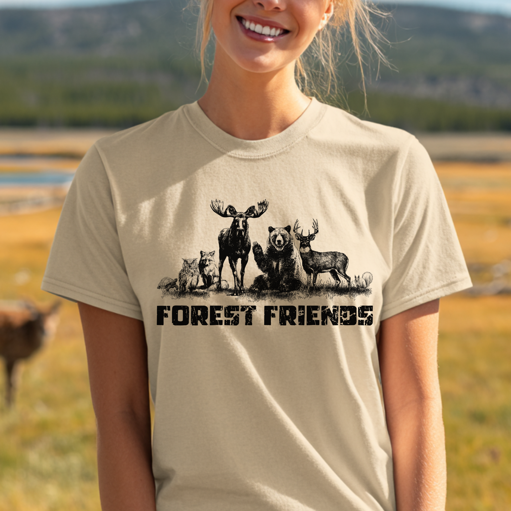 Person wearing a t-shirt with 'Forest Friends' design featuring animals in a natural setting