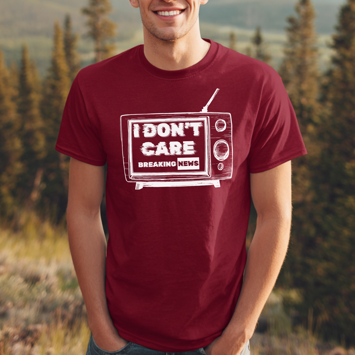 Person wearing a maroon t-shirt with a graphic of a TV and 'I Don't Care' text, standing outdoors.