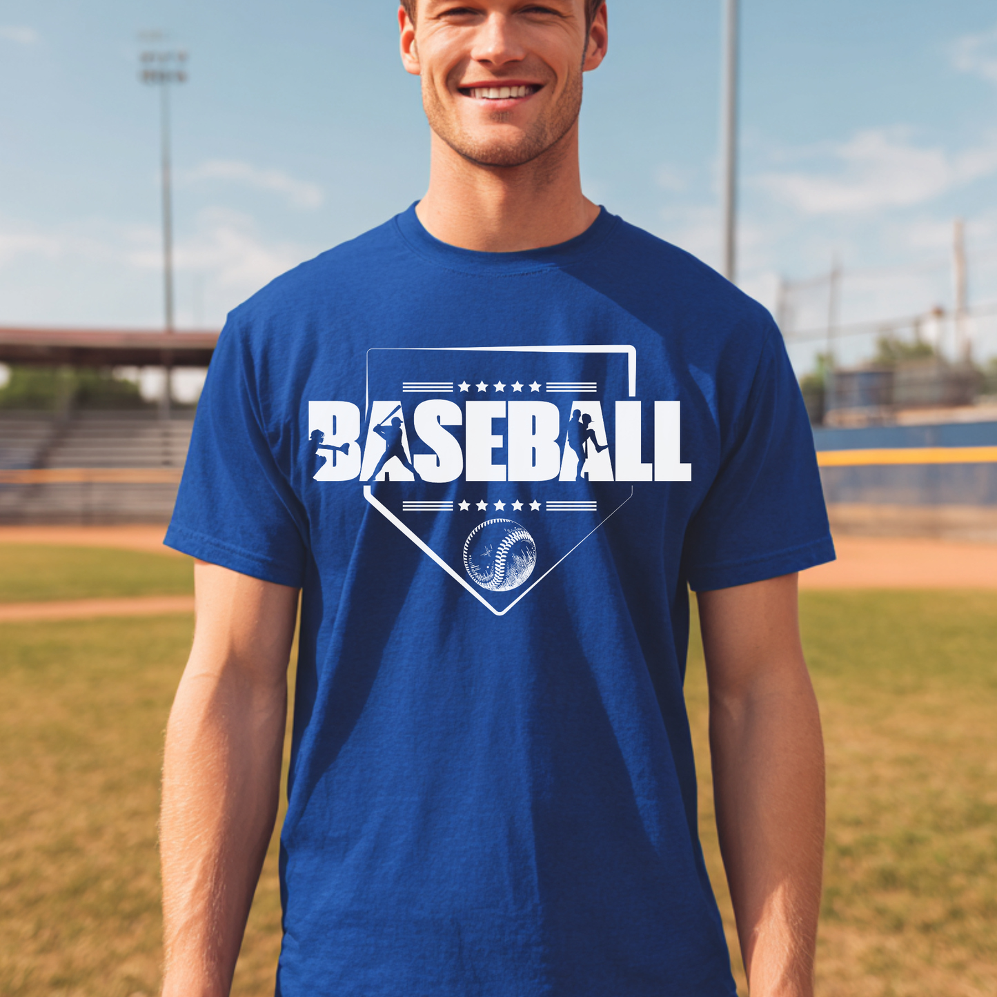 Man wearing a blue t-shirt with 'BASEBALL' printed on it, standing on a baseball field.