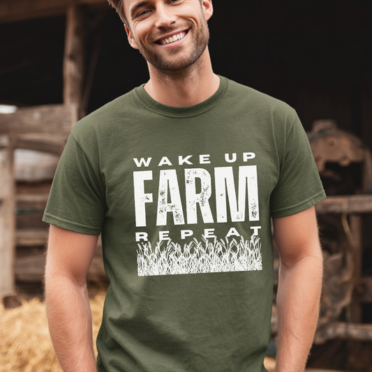 Man wearing a green t-shirt with 'Wake Up, Farm, Repeat' text in a barn setting