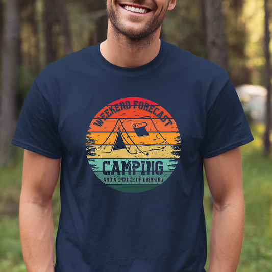 Man wearing a navy blue t-shirt with a colorful camping graphic and text in a forest setting.