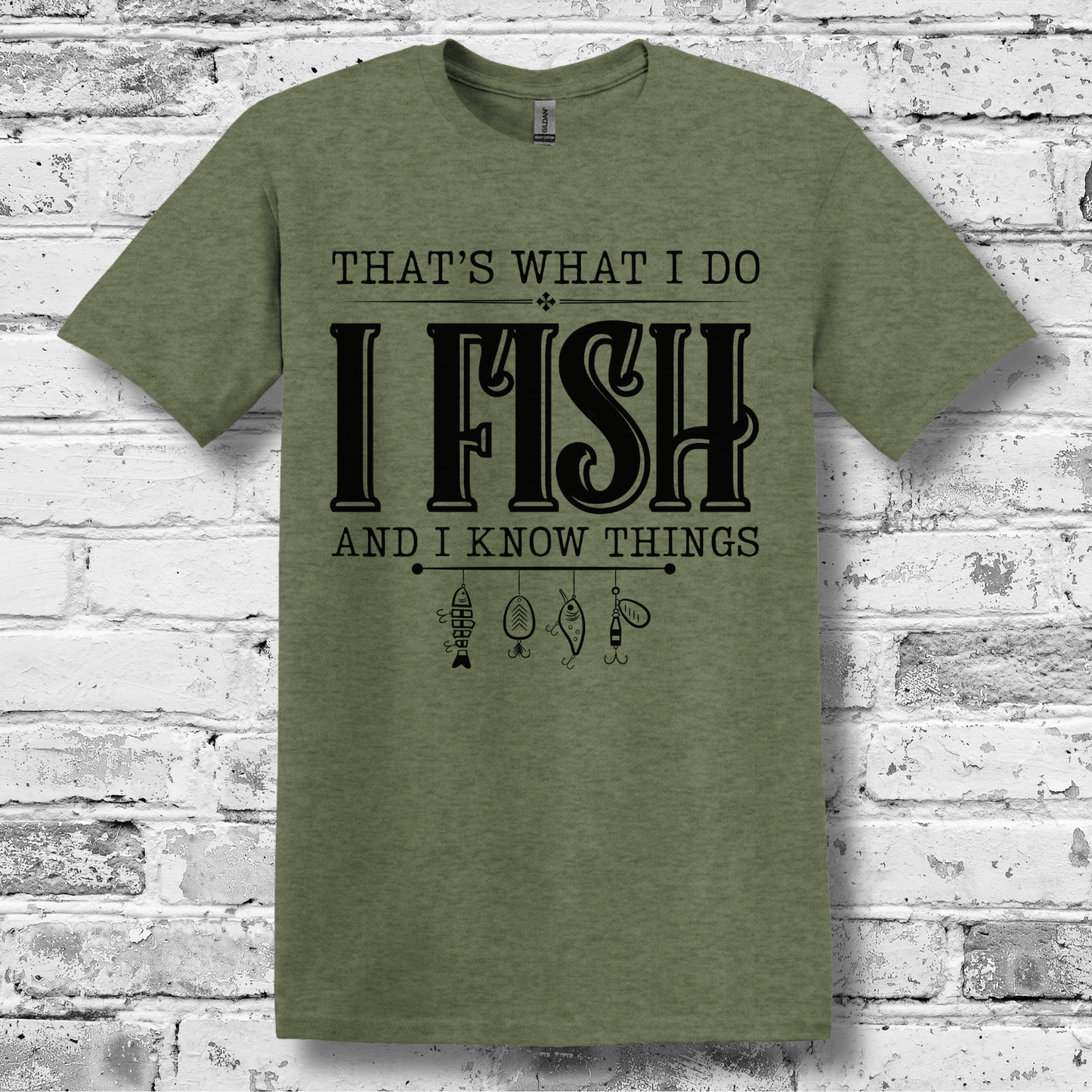Green t-shirt with text 'I Fish and I Know Things' on a brick wall background