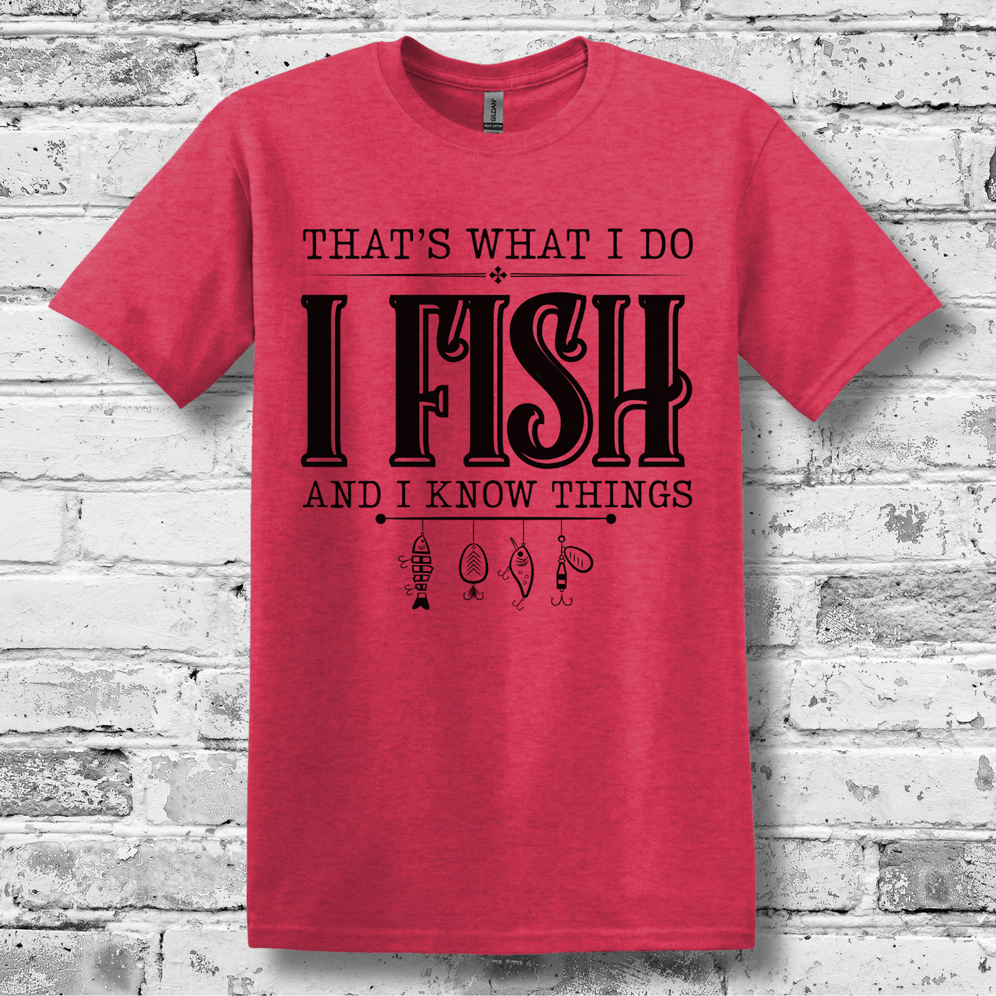 Red t-shirt with black text and graphics on a brick wall background