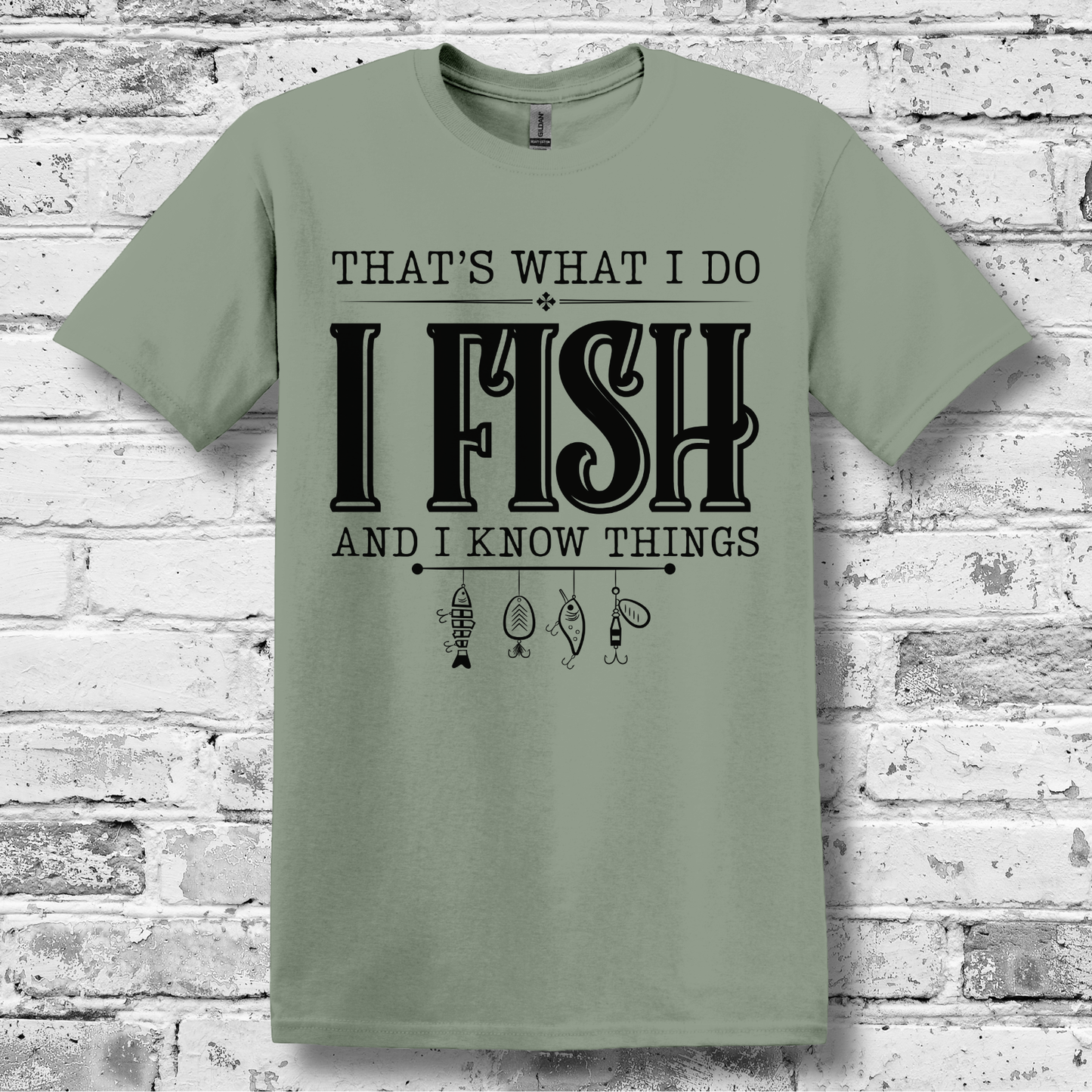 Green t-shirt with text 'I Fish and I Know Things' on a brick wall background